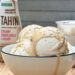 homemade ice cream with tahini served in a glass bowl with tahini drizzled on top