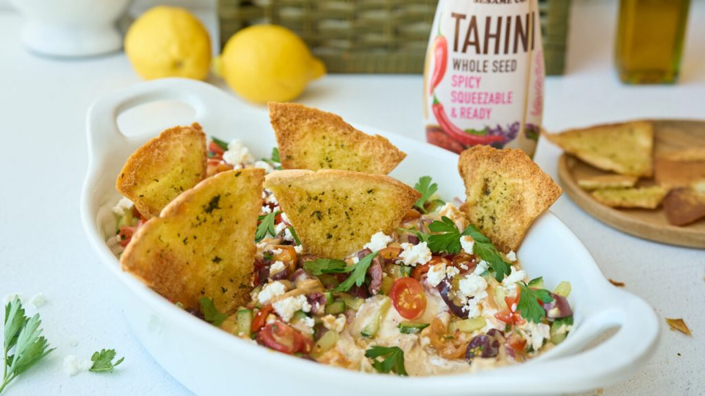 Tahini dip with feta, veggies, and toasted pita bread.